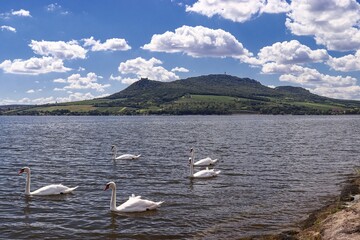 A view to the Palava hills and white clouds surrounded by the pond near Strachotin, Czech republic