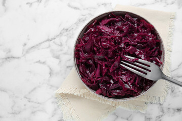 Obraz na płótnie Canvas Tasty red cabbage sauerkraut on white marble table, top view. Space for text