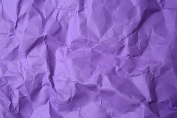 Fototapeta premium Sheet of crumpled violet paper as background, top view