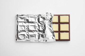 Tasty chocolate bar on white background, top view