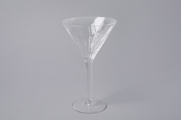 Empty clean martini glass on grey background