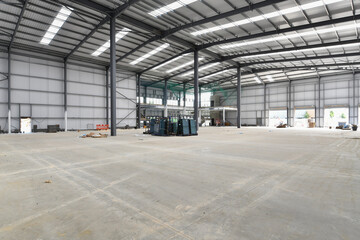 construction site of commercial warehouse building showing various materials and frame of building - 576032588