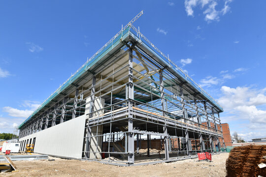construction site of commercial warehouse building showing various materials and frame of building .