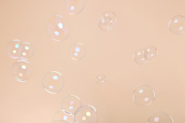 Many beautiful soap bubbles on beige background. Space for text