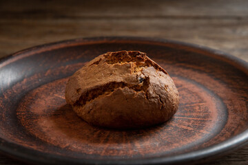 Homemade oatmeal cookies in a ceramic bowl on the kitchen table.