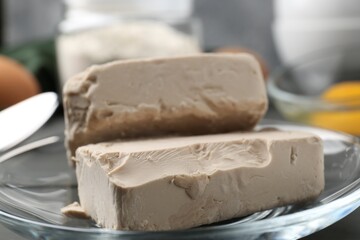 Fresh compressed yeast on grey table, closeup