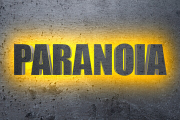 Mental disorder. Illuminated word Paranoia on grey stone background