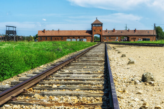 Famous entrance building of the concentration camp Birkenau with rails entering the camp