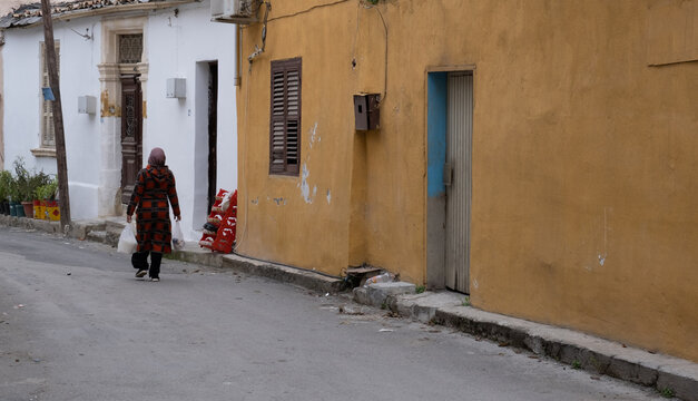 Unrecognized Adult woman walking in the street of a neighborhood  in  the city. Nicosia cyprus