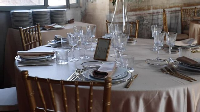 Wedding Day, catering and food. Details of an Hall of an ancient castle with catering for wedding events. The tables are set up with fine plates, glasses and cutlery