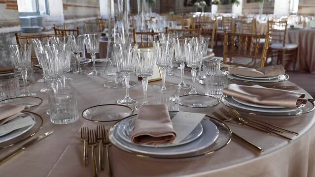 Wedding Day, catering and food. Hall of an ancient castle with catering for wedding events. The tables are set up with fine plates, glasses and cutlery
