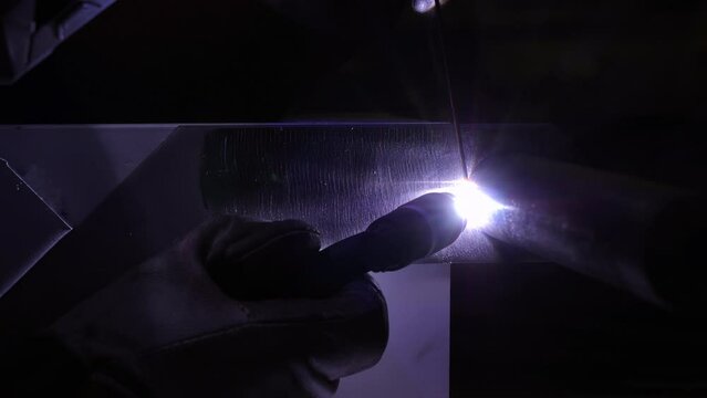 Close-Up Shot Of Sparks From Welding Torch On Machine In Dark Workshop - Granger, Indiana