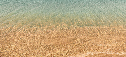 golden sand shore and sea water