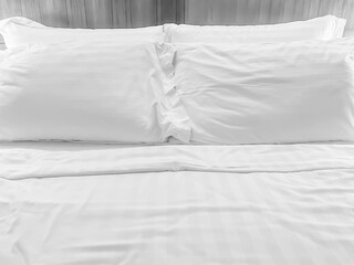 Black and white tone of bedding, wrinkled blanket or duvet and pillows in home or hotel 's bedroom