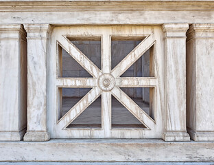 Marble balustrade section with a design that combines an X shape and a cross. Vintage architectural detail.