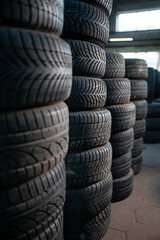 stack of car wheel tires at modern warehouse © goami