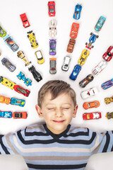 portrait of Caucasian child with toy cars