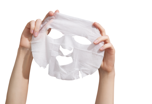 Female hands holding sheet of white mask on transparent background
