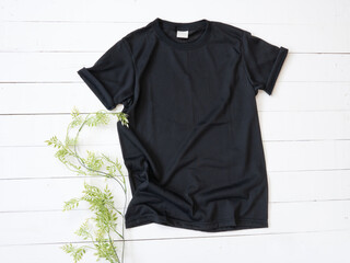 Black T Shirt mockup on white wood background