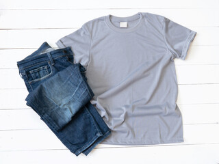 Grey T Shirt mockup and Jeans on white wood background
