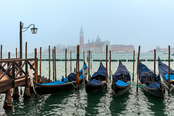 Obraz na płótnie Canvas Gondolas on Grand Canal as San Giorgio Maggiore church on background in Venice, Italy.