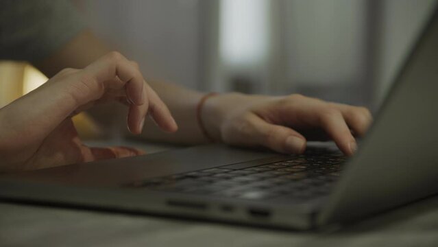 Unrecognizable woman hands swipe scroll on laptop touchpad