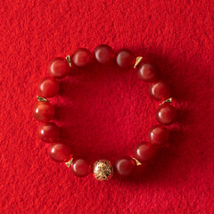bracelet on the hand made of red carnelian, a stone of health, well-being and success in all...