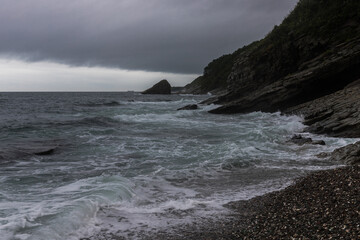 The sea before the storm.Dark stormy sea with dramatic sky and rocks
