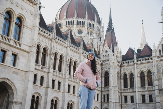 Young woman standing by classic building