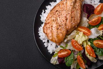 Delicious healthy breakfast consisting of chicken, rice, greens and cherry tomatoes