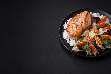 Delicious healthy breakfast consisting of chicken, rice, greens and cherry tomatoes