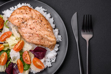 Delicious healthy breakfast consisting of chicken, rice, greens and cherry tomatoes