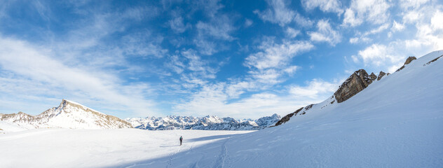 Man is snowshoe hiking in amazing alpine winter mountains landscape. Ifen, Haehlekopf, Vorarlberg, Austria. - 576067993