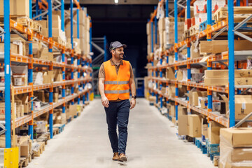 A post office worker is walking trough storage and searching for package.