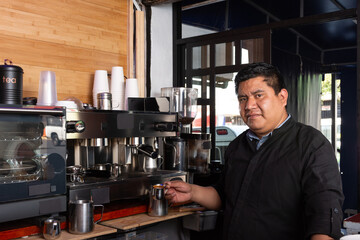 Fototapeta na wymiar Coffee Master: Portrait of the Barista preparing the perfect espresso