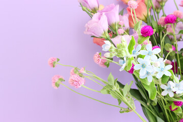 Fototapeta na wymiar Top view image of pink and purple flowers composition over pastel background