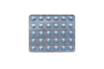 Medical blister packs with little blue pills isolated on white.