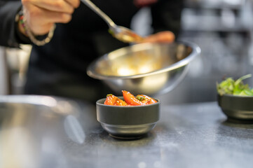Chef cooking vegetables salad on restaurant kitchen