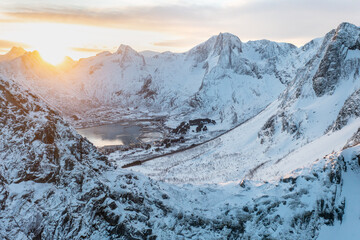 Snow covered mountain range on coastline in winter, Norway. Senja panoramic aerial view landscape nordic snow cold winter norway ocean cloudy sky snowy mountains. Troms county, Fjordgard 