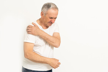 The elderly man suffering from the pain in this man's shoulder was extremely painful and held his shoulder