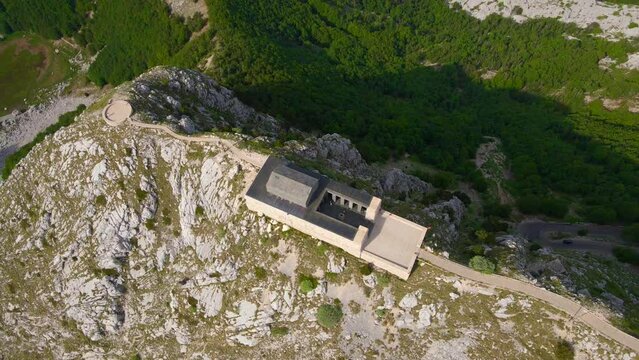 This stock video showcases the breathtaking aerial footage of the Njegos Mausoleum located at the top of the Jezerski peak in Montenegro. The mausoleum is a stunning architectural masterpiece