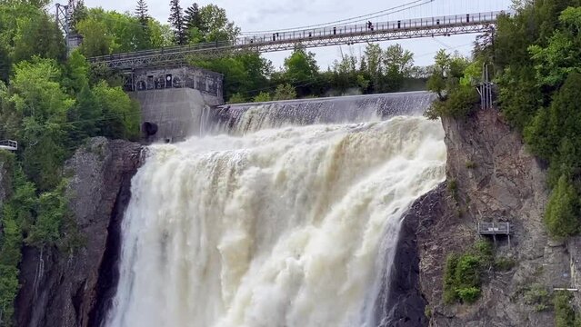 The Montmorency Falls (Chute Montmorency) Zip Line across large waterfall on Montmorency River where it drops into the Saint Lawrence River in Quebec, Canada. Protected within Montmorency Falls Park.