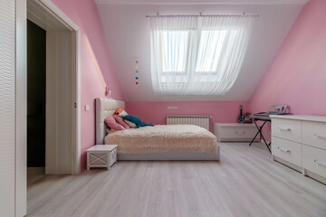 Girl bedroom with pink wall, table and toys in the attic