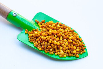 Yellow fertilizer plant food. High NPK