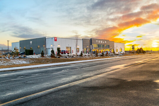 General view of a Tesla Automobile Sales and Service Center at sunset with snow visible on the ground at winter in Spokane, Washington USA, on February 26 2023.
