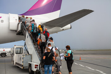 Passengers boarding on the airplane at the airfield in Stavanger, Norway