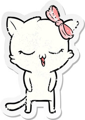 distressed sticker of a cartoon cat with bow on head