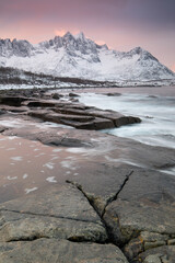 Snow covered mountain range on coastline in winter, Norway. Senja panoramic aerial view landscape nordic snow cold winter norway ocean cloudy sky snowy mountains. Troms county, Fjordgard 