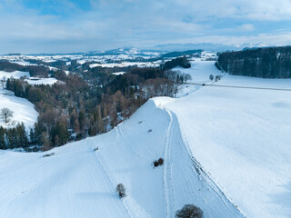 Aerial view of snow covered rural area in Canton of Fribourg in Switzerland in winter.