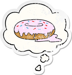 cartoon donut and thought bubble as a distressed worn sticker